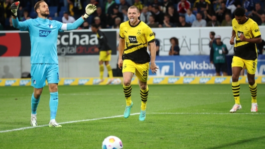 SINSHEIM, GERMANY - SEPTEMBER 29: Julian Ryerson of Borussia Dortmund celebrates his teams third goal past Goalkeeper, Oliver Baumann of TSG Hoffenheim during the Bundesliga match between TSG Hoffenheim and Borussia Dortmund at PreZero-Arena on September 29, 2023 in Sinsheim, Germany. (Photo by Alex Grimm/Getty Images)