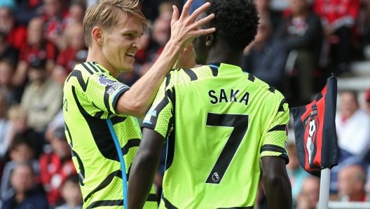 BOURNEMOUTH, ENGLAND - SEPTEMBER 30: Bukayo Saka of Arsenal celebrates with teammate Martin Odegaard after scoring the team's first goal during the Premier League match between AFC Bournemouth and Arsenal FC at Vitality Stadium on September 30, 2023 in Bournemouth, England. (Photo by Steve Bardens/Getty Images)