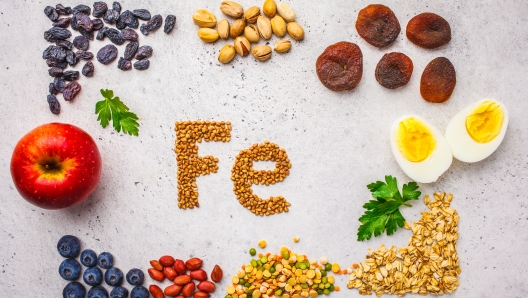 Healthy product sources of Fe. Top view, food background, iron ingredients: buckwheat, dried fruit, apple, eggs on a white background.