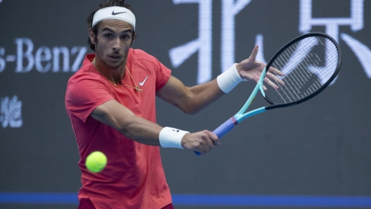 epa10893480 Lorenzo Musetti of Italy in action against Carlos Alcaraz of Spain during their second round match at the China Open tennis tournament, in Beijing, China, 01 October 2023.  EPA/ANDRES MARTINEZ CASARES