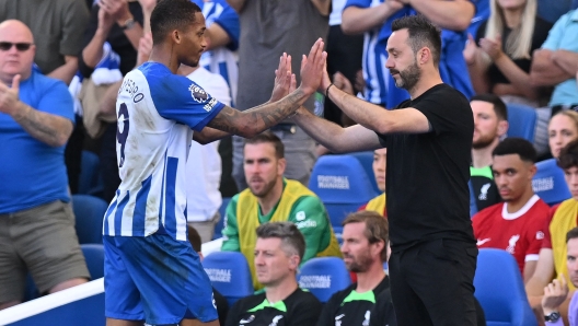 Brighton's Italian head coach Roberto De Zerbi (R) high-fives Brighton's Brazilian striker #09 Joao Pedro (L) as he leaves the game, substituted during the English Premier League football match between Brighton and Hove Albion and Liverpool at the American Express Community Stadium in Brighton, southern England on October 8, 2023. (Photo by Glyn KIRK / AFP) / RESTRICTED TO EDITORIAL USE. No use with unauthorized audio, video, data, fixture lists, club/league logos or 'live' services. Online in-match use limited to 120 images. An additional 40 images may be used in extra time. No video emulation. Social media in-match use limited to 120 images. An additional 40 images may be used in extra time. No use in betting publications, games or single club/league/player publications. /