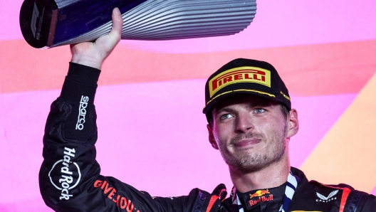 TOPSHOT - Red Bull Racing's Dutch driver Max Verstappen celebrates on the podium following the Qatari Formula One Grand Prix at Lusail International Circuit on October 8, 2023. (Photo by Giuseppe CACACE / AFP)