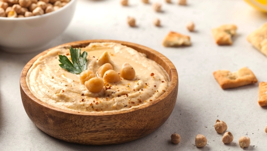 Banner hummus of their chickpeas in a wooden plate. Vegetarian food. High quality photo