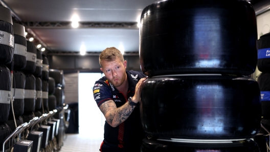 BARCELONA, SPAIN - JUNE 03: A Red Bull Racing team member pushes tyres in the Paddock prior to final practice ahead of the F1 Grand Prix of Spain at Circuit de Barcelona-Catalunya on June 03, 2023 in Barcelona, Spain. (Photo by Adam Pretty/Getty Images)