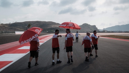 Gasgas Aspar Team's Moto2 rider Jake Dixon (3rd L) of Britain walks along the track ahead of the MotoGP Indonesian Grand Prix at the Mandalika International Circuit in Kuta Mandalika, Central Lombok, on October 12, 2023. (Photo by Yasuyoshi CHIBA / AFP)