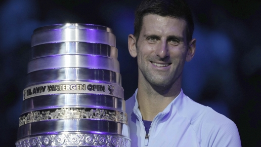 Serbia's Novak Djokovic poses with the trophy after winning the final tennis match of the ATP 250 Tel Aviv open against Croatia's Marin Cilic in Tel Aviv, Israel, Sunday, Oct. 2, 2022. (AP Photo/Ariel Schalit)