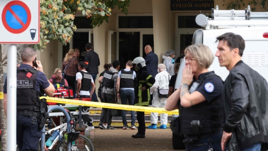 French police officers from the forensic service stand in front of the Gambetta high school in Arras, northeastern France on October 13, 2023, after a teacher was killed and two other people severely wounded in a knife attack, police and regional officials said. The perpetrator has been detained by police, Interior Minister Gerald Darmanin wrote on X, formerly Twitter. (Photo by Denis CHARLET / AFP)