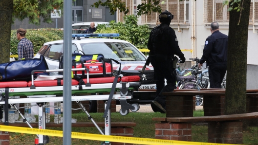 French police officers stand in front of the Gambetta high school in Arras, northeastern France on October 13, 2023, after a teacher was killed and two other people severely wounded in a knife attack, police and regional officials said. The perpetrator has been detained by police, Interior Minister Gerald Darmanin wrote on X, formerly Twitter. (Photo by Denis CHARLET / AFP)