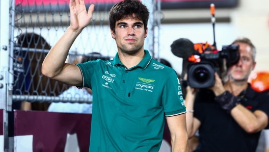 LUSAIL CITY, QATAR - OCTOBER 08: Lance Stroll of Canada and Aston Martin F1 Team waves to the crowd on the drivers parade prior to the F1 Grand Prix of Qatar at Lusail International Circuit on October 08, 2023 in Lusail City, Qatar. (Photo by Clive Rose/Getty Images)