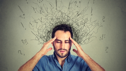 man thinking very intensely concentrating isolated on gray wall background