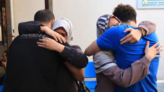 Palestinian women are comforted as they arrive to collect the bodies of a relative from the hospital, following Israeli military attacks on Rafah, in the southern of Gaza Strip on October 16, 2023. The death toll from Israeli strikes on the Gaza Strip has risen to around 2,750 since Hamas's deadly attack on southern Israel last week, the Gaza health ministry said October 16. Some 9,700 people have also been injured as Israel continued its withering air campaign on targets in the Palestinian coastal enclave, the Hamas-controlled ministry added. (Photo by SAID KHATIB / AFP)