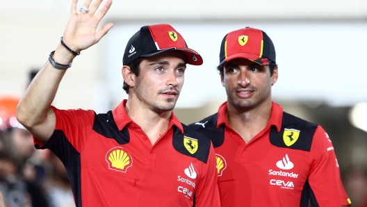 LUSAIL CITY, QATAR - OCTOBER 08: Charles Leclerc of Monaco and Ferrari and Carlos Sainz of Spain and Ferrari look on from the drivers parade prior to the F1 Grand Prix of Qatar at Lusail International Circuit on October 08, 2023 in Lusail City, Qatar. (Photo by Clive Rose/Getty Images)