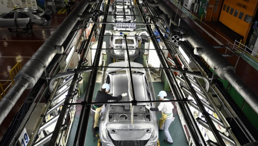 epa10826362 (FILE) - Workers check the surface of vehicles at the Toyota Tsutsumi car assembly plant in Toyota, near Nagoya, central Japan, 08 December 2017 (reissued 29 August 2023). Toyota Motor Corporation announced on 29 August 2023 that production lines at 12 plants in Japan had been shut down since the morning due to a failure in the automaker's computer system managing parts orders. Additional lines at two other plants are also scheduled to stop production in the evening, causing the suspension of all vehicle production in Japan. The cause is under investigation.  EPA/FRANCK ROBICHON