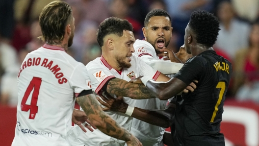 Real Madrid's Vinicius Junior, right, argues with Sevilla players during a Spanish La Liga soccer match between Sevilla and Real Madrid, at the Ramon Sanchez Pizjuan stadium in Seville, Spain, Saturday, Oct. 21, 2023. (AP Photo/Jose Breton)