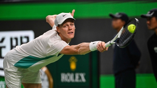 Italy's Jannik Sinner hits a return to US's Ben Shelton in their men's singles match during the Shanghai Masters tennis tournament in Shanghai on October 10, 2023. (Photo by Hector RETAMAL / AFP)