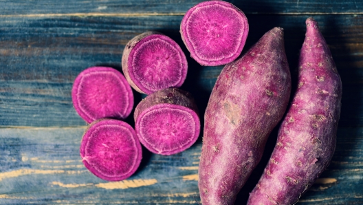 Purple sweet potatoes on wooden