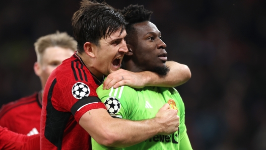 MANCHESTER, ENGLAND - OCTOBER 24: Andre Onana and Harry Maguire of Manchester United celebrate after saving a penalty from Jordan Larsson of FC Copenhagen (not pictured) during the UEFA Champions League match between Manchester United and F.C. Copenhagen at Old Trafford on October 24, 2023 in Manchester, England. (Photo by Catherine Ivill/Getty Images)