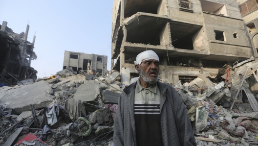 A Palestinian stands outside the building destroyed i the Israeli bombardment of the Gaza Strip in Rafah, Wednesday, Oct 25, 2023. (AP Photo/Hatem Ali)