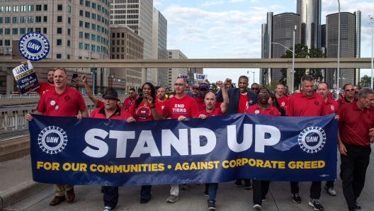 (FILES) (FILES) Members of the United Auto Workers (UAW) union march through the streets of downtown Detroit following a rally on the first day of the UAW strike in Detroit, Michigan, on September 15, 2023. An auto workers strike in the United States expanded October 11, 2023 with 8,700 more employees walking off their jobs, said the United Automobile Workers (UAW) union, as a deal with major automakers remained elusive. (Photo by Matthew Hatcher / AFP)