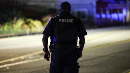 epa10939839 A law enforcement officer walks along the road leading to the Schemengees bar where a man on late 25 October reportedly opened fire killing and injuring numerous people in Lewiston, in Lisbon, Maine, USA, 26 October 2023. Early reports indicate as many as 20 people have been killed, and dozens injured. Police are still searching for the suspect.  EPA/CJ GUNTHER