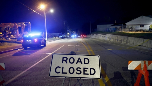 epa10939778 A police car drives toward Schemengees bar where a man reportedly opened fire killing and injuring numerous people in Lewiston, Maine, USA, 25 October 2023. Early reports indicate as many as 20 people have been killed, and dozens injured. Police are still searching for the suspect.  EPA/CJ GUNTHER