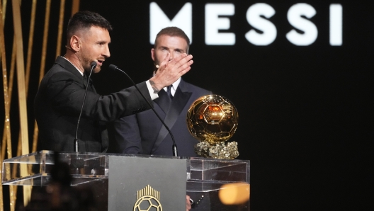 Inter Miami's and Argentina's national team player Lionel Messi, left, gestures as he receive the 2023 Ballon d'Or trophy from during the 67th Ballon d'Or (Golden Ball) award ceremony at Theatre du Chatelet in Paris, France, Monday, Oct. 30, 2023, Inter Miami team co-owner and former soccer star David Beckham is on the right. (AP Photo/Michel Euler)