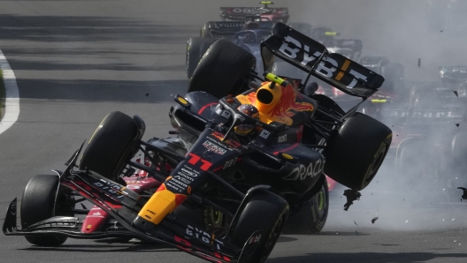 Red Bull driver Sergio Perez of Mexico, front, crashes with Ferrari driver Charles Leclerc of Monaco after the start of the Formula One Mexico Grand Prix auto race at the Hermanos Rodriguez racetrack in Mexico City, Sunday, Oct. 29, 2023. (AP Photo/Fernando Llano)