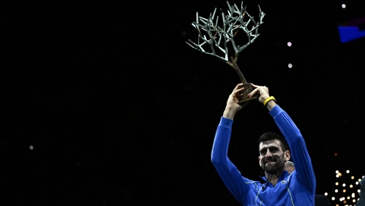 Serbia's Novak Djokovic celebrates with the trophy after winning the men's singles final match of the Paris ATP Masters 1000 tennis tournament against Bulgaria's Grigor Dimitrov, at the Accor Arena - Palais Omnisports de Paris-Bercy - in Paris on November 5, 2023. (Photo by JULIEN DE ROSA / AFP)