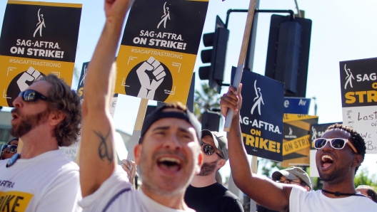 LOS ANGELES, CALIFORNIA - NOVEMBER 08: SAG-AFTRA members and supporters chant outside Paramount Studios on day 118 of their strike against the Hollywood studios on November 8, 2023 in Los Angeles, California. A tentative labor agreement has been reached between the actors union and the Alliance of Motion Picture and Television Producers (AMPTP) with the strike set to end after midnight.   Mario Tama/Getty Images/AFP (Photo by MARIO TAMA / GETTY IMAGES NORTH AMERICA / Getty Images via AFP)