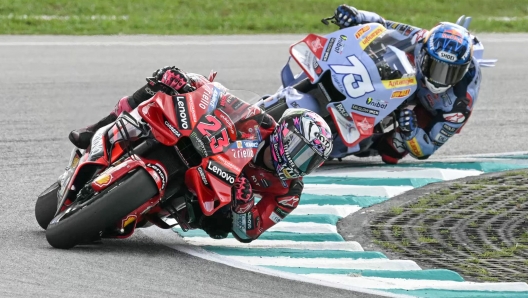 Ducati Lenovo Team's Italian rider Enea Bastianini competes ahead of Gresini Racing MotoGP's Spanish rider Alex Marquez during the MotoGP Malaysian Grand Prix at the Sepang International Circuit in Sepang on November 12, 2023. (Photo by MOHD RASFAN / AFP)