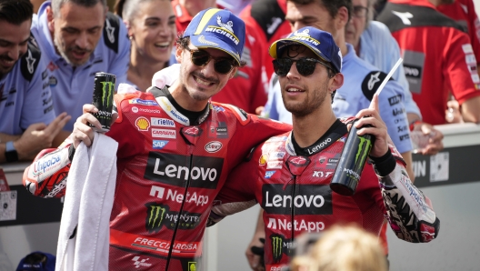 Winner Italian rider Enea Bastianini, right, and third-placed Italian rider Francesco Bagnaia pose for photographers after the MotoGP class race of the MotoGP Malaysian Grand Prix at the Sepang, Malaysia Sunday, Nov. 12, 2023. (AP Photo/Vincent Thian)