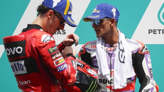 epa10969276 Italian MotoGP rider Francesco Bagnaia (L) of Ducati Lenovo Team celebrates securing the pole position with second place Spanish MotoGP rider Jorge Martin (R) of Prima Pramac Racing after the qualifying session of the Malaysia Motorcycling Grand Prix 2023 in Petronas Sepang International Circuit, in Sepang, Malaysia, 11 November 2023.  EPA/FAZRY ISMAIL