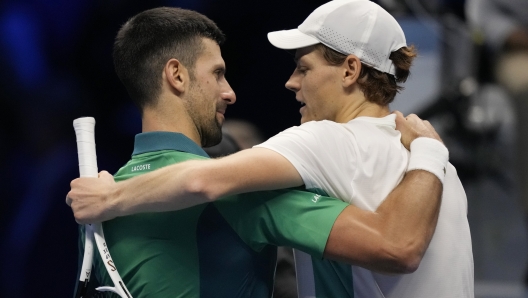 Italy's Jannik Sinner, right, embraces Serbia's Novak Djokovic at the end of the singles tennis match of the ATP World Tour Finals at the Pala Alpitour, in Turin, Italy, Tuesday, Nov. 14, 2023. (AP Photo/Antonio Calanni)