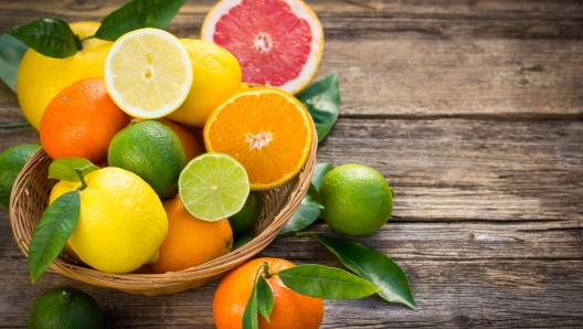 Citrus fruits in the basket on the rustic table