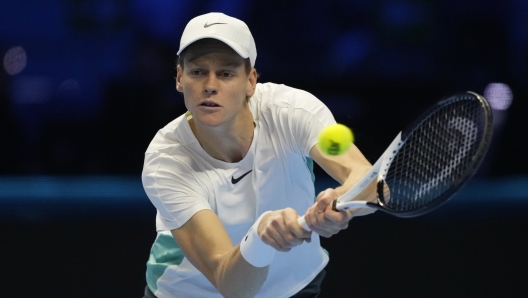 Italy's Jannik Sinner returns the ball to Denmark's Holger Rune during their singles tennis match of the ATP World Tour Finals at the Pala Alpitour, in Turin, Italy, Thursday, Nov. 16, 2023. (AP Photo/Antonio Calanni)