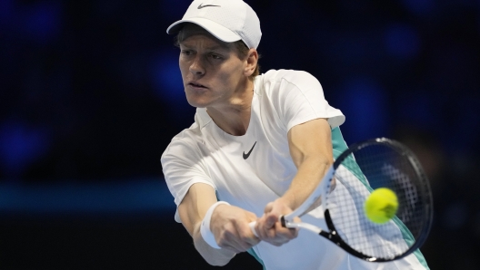 Italy's Jannik Sinner returns the ball to Denmark's Holger Rune during their singles tennis match of the ATP World Tour Finals at the Pala Alpitour, in Turin, Italy, Thursday, Nov. 16, 2023. (AP Photo/Antonio Calanni)