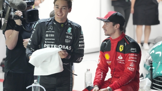 Ferrari driver Charles Leclerc, right, of Monaco talks with Mercedes driver George Russell of Britain after the qualifying session of the Singapore Formula One Grand Prix at the Marina Bay circuit, Singapore, Saturday, Sept. 16, 2023. Russell took second while Leclerc is third during qualifying.(AP Photo/Vincent Thian)