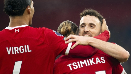 epa10971817 Diogo Jota (R) of Liverpool celebrates with teammates Konstantinos Tsimikas (C) and Virgil van Dijk after scoring the 3-0 goal during the English Premier League soccer match between Liverpool FC and Brentford FC, in Liverpool, Britain, 12 November 2023.  EPA/PETER POWELL No use with unauthorized audio, video, data, fixture lists, club/league logos, 'live' services' or as NFTs. Online in-match use limited to 120 images, no video emulation. No use in betting, games or single club/league/player publications.