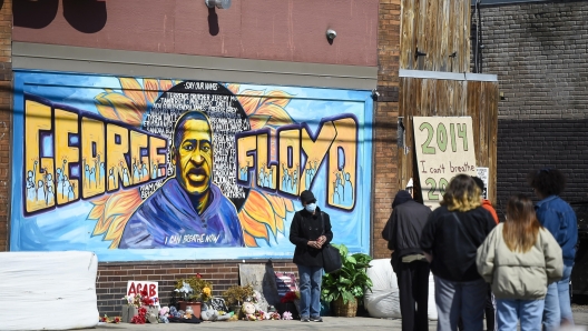 epa09105503 After nearly a year, a memorial to George Floyd still gathers onlookers outside of Cup Foods, the site where Floyd died in police custody, in Minneapolis, Minnesota, USA, 29 March 2021. Opening statements for the murder trial of former Minneapolis police officer Derek Chauvin who was charged in the death of George Floyd begins today.  EPA/CRAIG LASSIG