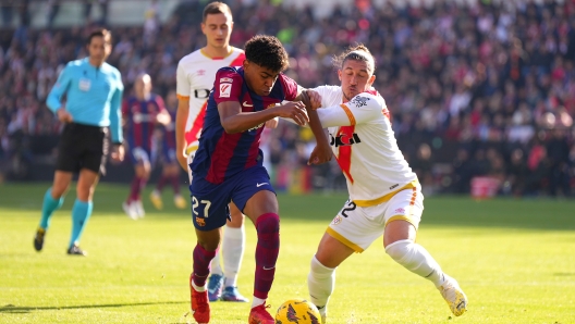 MADRID, SPAIN - NOVEMBER 25: Lamine Yamal of FC Barcelona and Alfonso Espino of Rayo Vallecano battle for possession during the LaLiga EA Sports match between Rayo Vallecano and FC Barcelona at Estadio de Vallecas on November 25, 2023 in Madrid, Spain. (Photo by Angel Martinez/Getty Images)