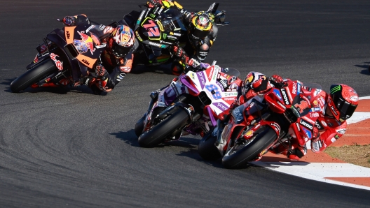 (From R) Ducati Italian rider Francesco Bagnaia, Ducati Spanish rider Jorge Martin, KTM Australian rider Jack Miller and Aprilia Spanish rider Maverick Vinales compete in the sprint race of the MotoGP Valencia Grand Prix at the Ricardo Tormo racetrack in Cheste, on November 25, 2023. (Photo by JOSE JORDAN / AFP)