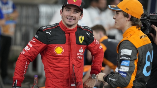 Ferrari driver Charles Leclerc of Monaco, left, chats with McLaren driver Oscar Piastri of Australia after qualifying session ahead of the Abu Dhabi Formula One Grand Prix at the Yas Marina Circuit, Abu Dhabi, UAE, Saturday, Nov. 25, 2023. (AP Photo/Kamran Jebreili)