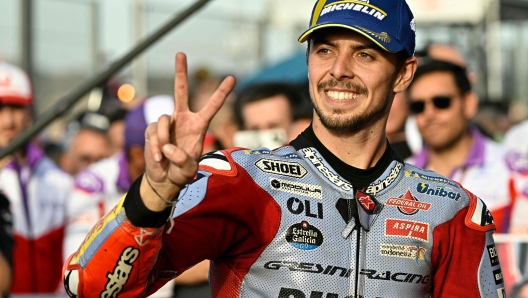 Ducati Italian rider Fabio Di Giannantonio celebrates his second place in the MotoGP Valencia Grand Prix at the Ricardo Tormo racetrack in Cheste, on November 26, 2023. Italy's Francesco Bagnaia enjoyed a dream day as he retained his MotoGP world title and crowned it with victory in the final race of the season in Valencia today. The 26-year-old Ducati rider had been assured of the championship when his sole rival Jorge Martin crashed early in the race. (Photo by JAVIER SORIANO / AFP)