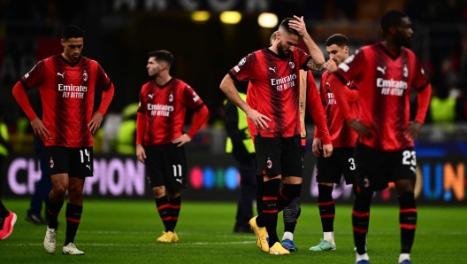 AC Milan's French forward #09 Olivier Giroud and teammates react at the end of the UEFA Champions League Group F football match between AC Milan and Borussia Dortmund at the San Siro stadium in Milan on November 28, 2023. (Photo by Marco BERTORELLO / AFP)