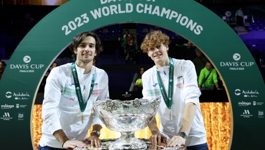 MALAGA, SPAIN - NOVEMBER 26: Lorenzo Musetti and Jannik Sinner of Italy celebrate with the Davis Cup Trophy after their teams victory during the Davis Cup Final match against Australia at Palacio de Deportes Jose Maria Martin Carpena on November 26, 2023 in Malaga, Spain. (Photo by Clive Brunskill/Getty Images for ITF)