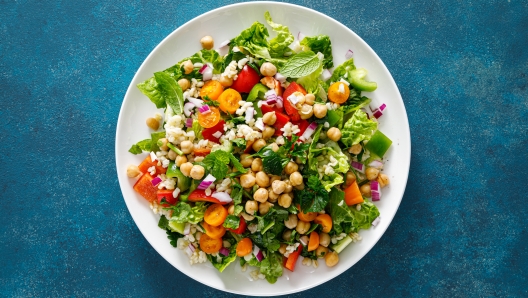 Tabbouleh salad. Tabouli salad with fresh parsley, onions, tomatoes, bulgur and chickpea. Healthy vegetarian food, diet. Top view