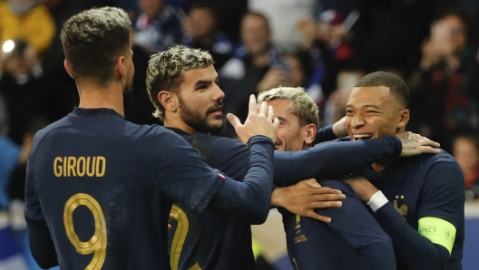 France's Kylian Mbappe, right, celebrates with teammates after he scored his side's third goal during the friendly soccer match between France and Scotland at the Pierre Mauroy stadium, in Villeneuve-d'Ascq, northern France, Tuesday, Oct 17, 2023. (AP Photo/Michel Spingler)