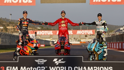 Moto GP World Champion Italian rider Francesco Bagnaia of the Ducati Lenovo Team, center, poses with Moto2 World Champion Spain's rider Pedro Acosta of the Red Bull KTM Ajo, left, and Moto 3 World Champion Spain's rider Jaume Masia of the Leopard Racing after the last race of the season, at the Ricardo Tormo circuit in Cheste near Valencia, Spain, Sunday, Nov. 26, 2023. (AP Photo/Alberto Saiz)