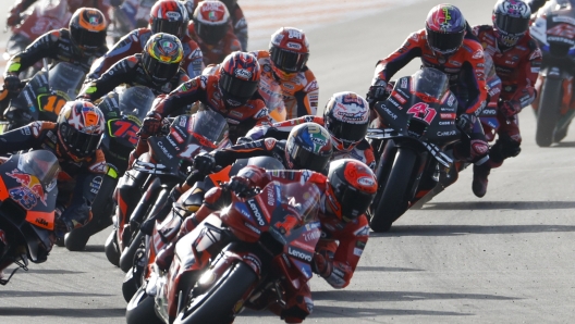 Italian rider Francesco Bagnaia of the Ducati Lenovo Team leads the pack at the start of the MotoGP race of the Valencia Motorcycle Grand Prix, the last race of the season, at the Ricardo Tormo circuit in Cheste near Valencia, Spain, Sunday, Nov. 26, 2023. (AP Photo/Alberto Saiz)