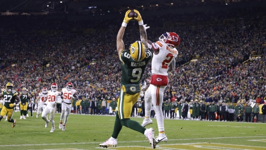 Green Bay Packers wide receiver Christian Watson (9) catches a 12-yard touchdown pass as Kansas City Chiefs cornerback Joshua Williams (2) defends during the second half of an NFL football game Sunday, Dec. 3, 2023 in Green Bay, Wis. (AP Photo/Matt Ludtke)